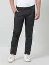 Man wearing a balck solid slim fit trouser with casual styling on a gray background
