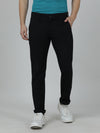 Man wearing a black solid slim fit casual black trouser with casual styling on a gray background
