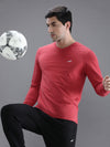 Man wearing a red red melange solid t shirt with casual styling on a gray background