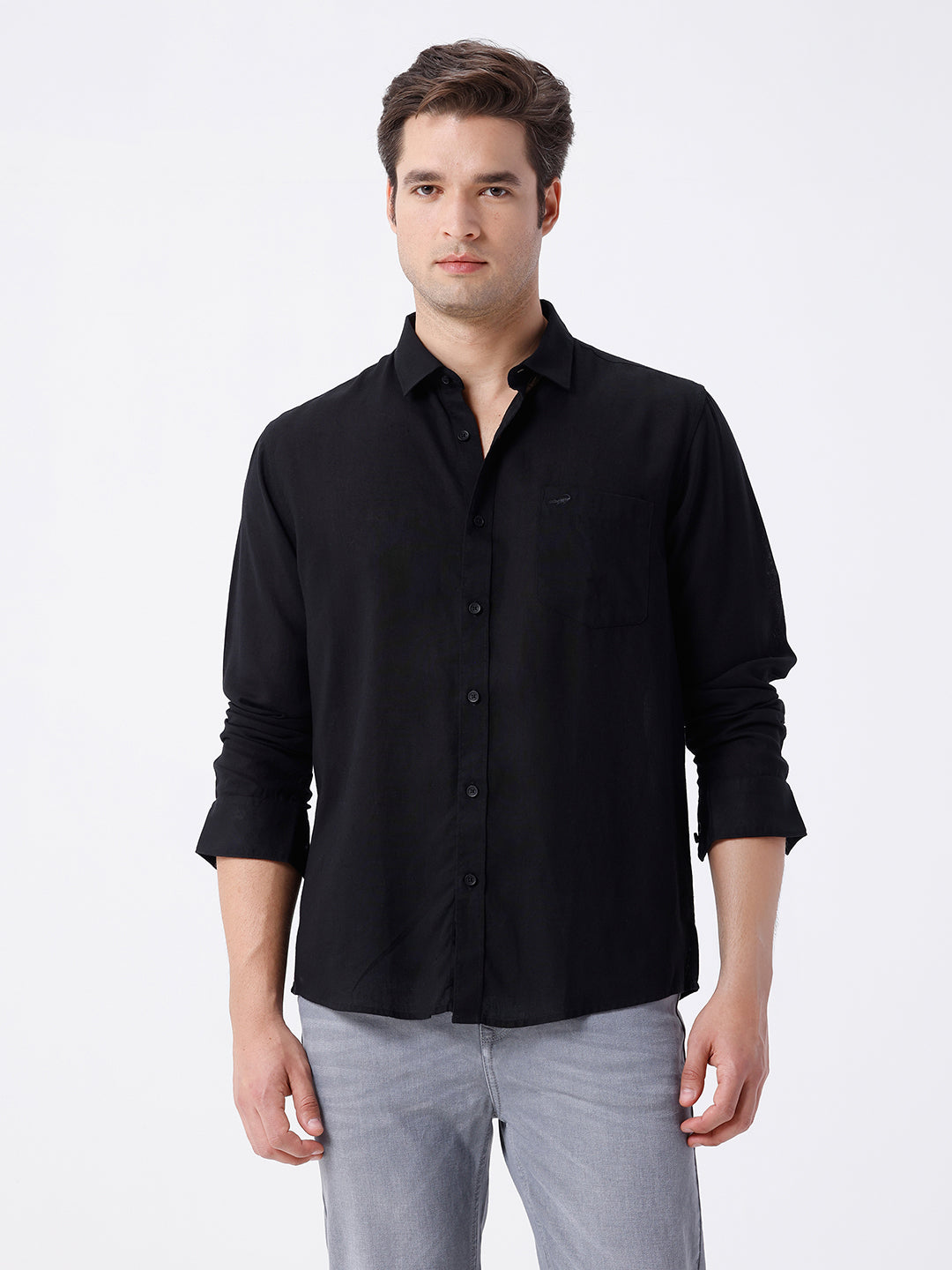 Man wearing a black linen blend shirt in black with casual styling on a gray background