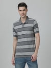 Man wearing a grey charcoal grey striped polo t shirt on a light gray background