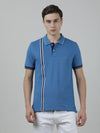 Man wearing a blue atlantic blue printed polo t shirt with casual styling on a gray background