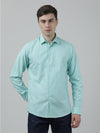 Man wearing a green solid casual full sleeve 100% cotton shirt green with casual styling on a gray background