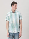 Man wearing a blue aqua blue checked half sleeve 100% cotton shirt on a light gray background