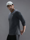 Man wearing a grey casual charcoal melange grey solid t shirt with casual styling on a gray background