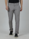 Man wearing a grey grey solid casual slim fit trouser with casual styling on a gray background
