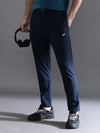 Man wearing a navy solid navy regular fit track pant on a light gray background