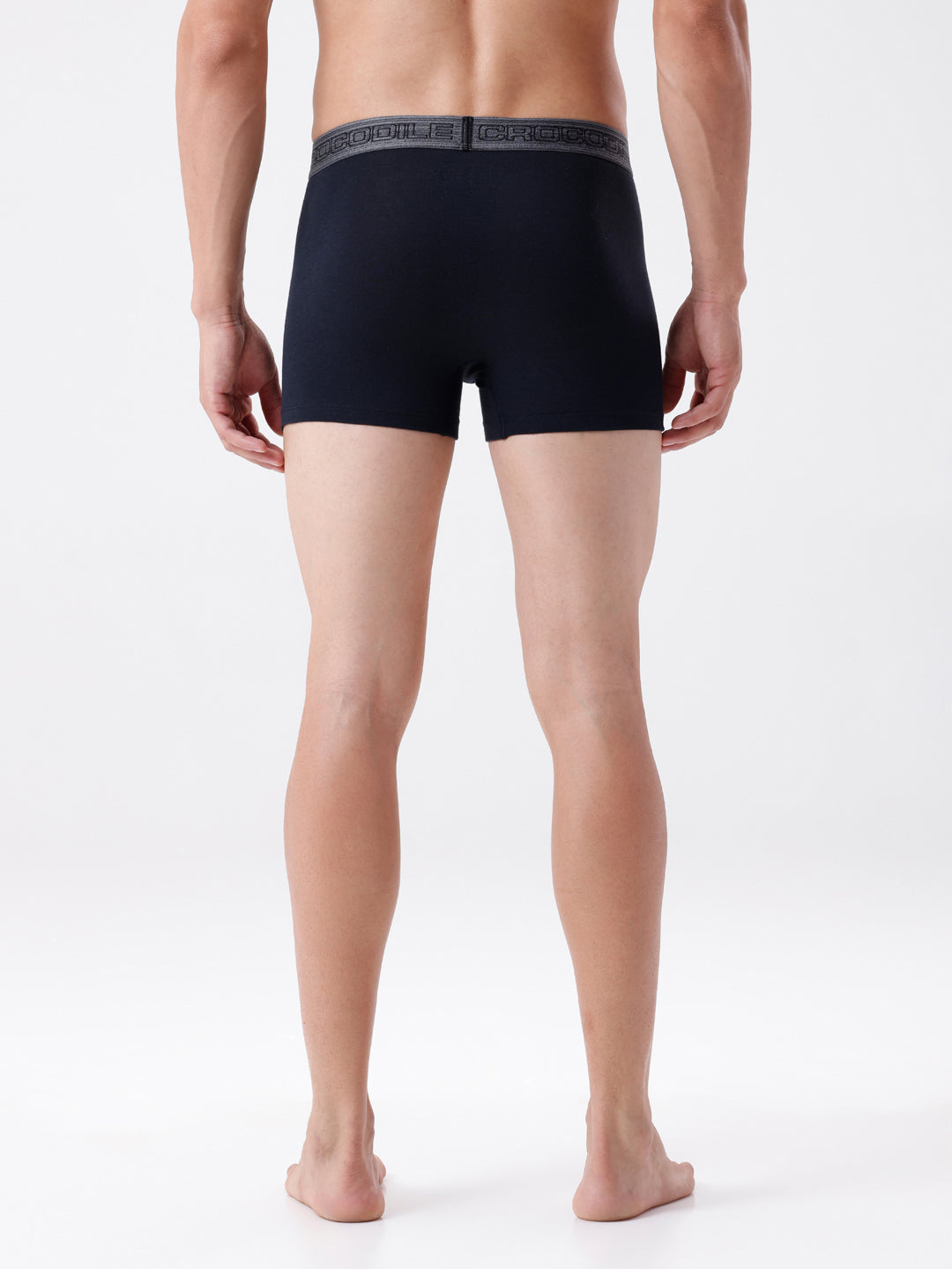 Person wearing black boxer briefs on a white background