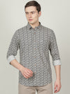 Man wearing a navy dark navy printed casual full sleeve 100% cotton shirt on a light gray background