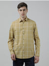Man wearing a yellow mustard yellow checked full sleeve 100% cotton shirt with casual styling on a gray background