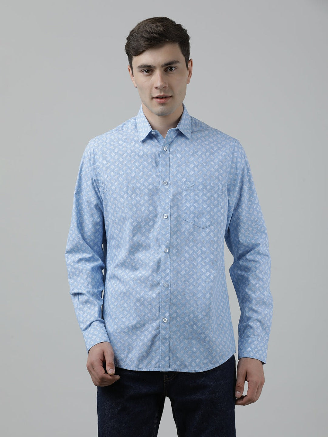 Man wearing a blue sky blue printed full sleeve 100% cotton shirt with casual styling on a gray background