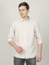 Man wearing a beige beige solid full sleeve linen shirt on a light gray background