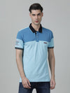 Man wearing a blue light blue colourblocked polo t shirt with casual styling on a gray background