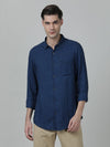 Man wearing a navy indigo navy solid full sleeve shirt with casual styling on a gray background