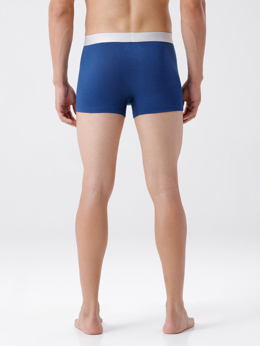 Person wearing blue boxer briefs on a white background