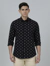 Man wearing a black black printed full sleeve shirt on a light gray background