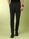 Man wearing a grey dark grey solid slim fit casual trouser with casual styling on a gray background