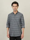 Man wearing a grey dark grey striped full sleeve 100% cotton shirt with casual styling on a gray background