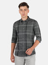 Man wearing a grey dark grey casual checked full sleeve shirt on a light gray background