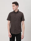 Man wearing a brown brown checked half sleeve shirt with casual styling on a gray background