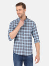 Man wearing a blue checked full sleeve blue shirt on a light gray background