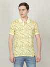 Man wearing a yellow yellow casual printed polo t shirt with casual styling on a gray background
