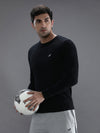 Man wearing a black casual black solid t shirt on a light gray background