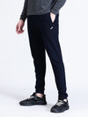 Man wearing a navy solid navy comfort fit joggers on a light gray background