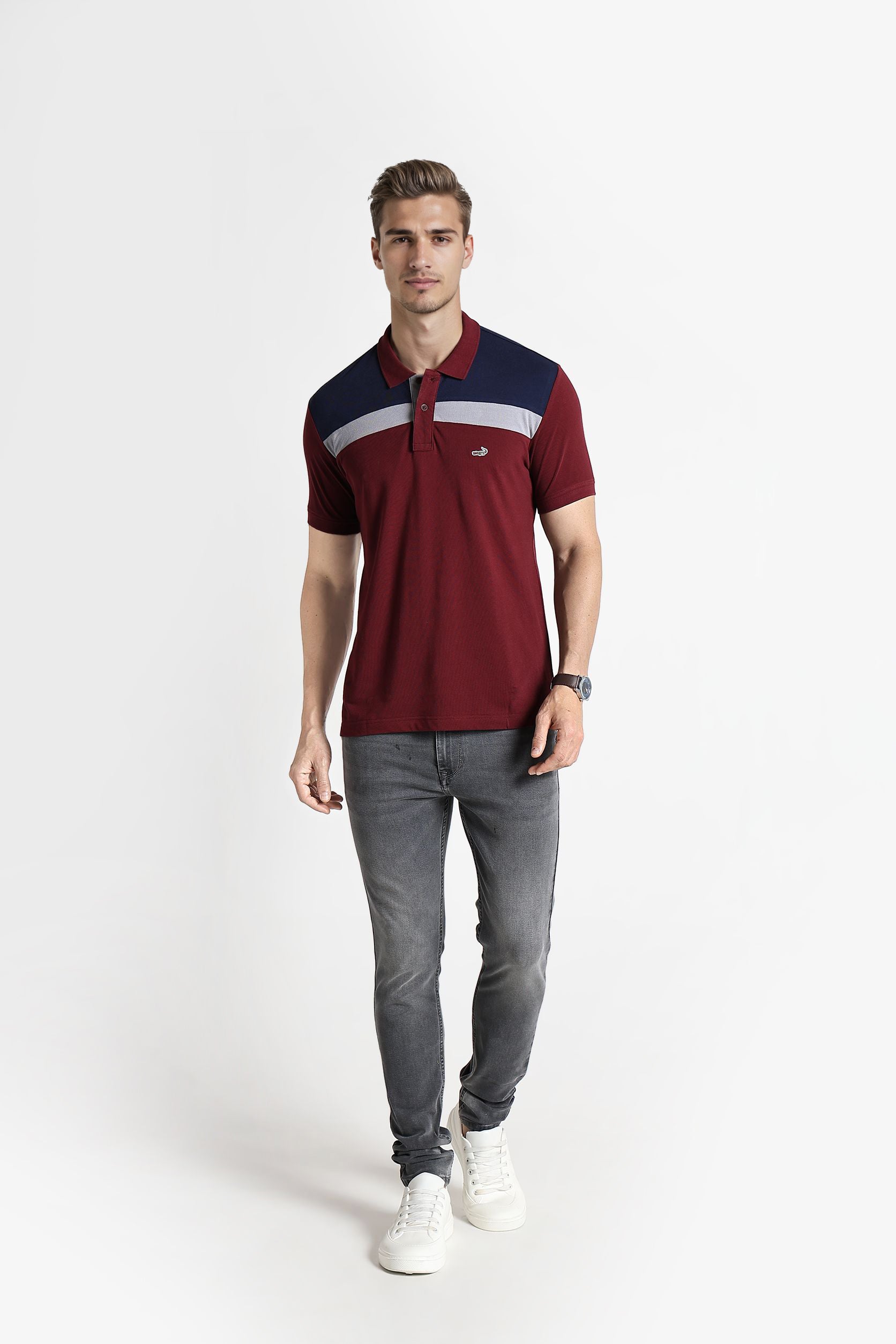 Man wearing a maroon polo shirt with navy and white accents on a white background