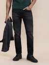 Man wearing a red natural fade wash slim tapered jeans on a light gray background