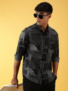 Man wearing a green printed full sleeve 100% cotton green shirt with casual styling on a gray background