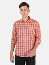 Man wearing a pink coral pink checked full sleeve shirt with casual styling on a gray background