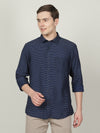 Man wearing a navy navy striped full sleeve casual shirt with casual styling on a gray background