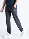 Man wearing a grey solid classic fit charcoal grey joggers with casual styling on a gray background