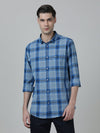 Man wearing a blue blue checked casual full sleeve 100% cotton shirt on a light gray background