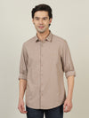 Man wearing a yellow golden yellow solid full sleeve 100% cotton shirt with casual styling on a gray background