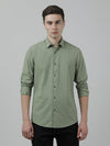 Man wearing a green casual olive green checked full sleeve 100% cotton shirt on a light gray background