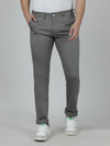 Man wearing a grey casual grey solid slim fit trouser with casual styling on a gray background