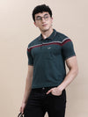 Man wearing a green slim fit green striper t shirt on a light gray background