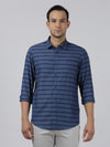 Man wearing a navy navy casual striped full sleeve 100% cotton shirt on a light gray background
