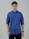 Man wearing a blue royal blue checked full sleeve shirt on a light gray background