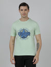 Man wearing a green typography printed single jersey cotton t shirt green with casual styling on a gray background