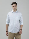 Man wearing a blue sky blue printed full sleeve linen shirt on a light gray background
