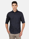Man wearing a navy dark navy solid full sleeve linen shirt on a light gray background