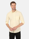 Man wearing a yellow yellow solid full sleeve shirt on a light gray background