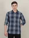 Man wearing a navy indigo navy checked full sleeve 100% cotton casual shirt on a light gray background