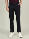 Man wearing a navy navy solid slim fit casual trouser on a light gray background