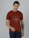 Man wearing a brown typography printed single jersey cotton brown t shirt with casual styling on a gray background
