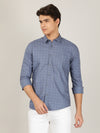 Man wearing a blue light blue printed full sleeve 100% cotton casual shirt on a light gray background