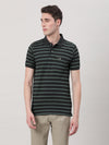 Man wearing a green striped green casual polo t shirt with casual styling on a gray background